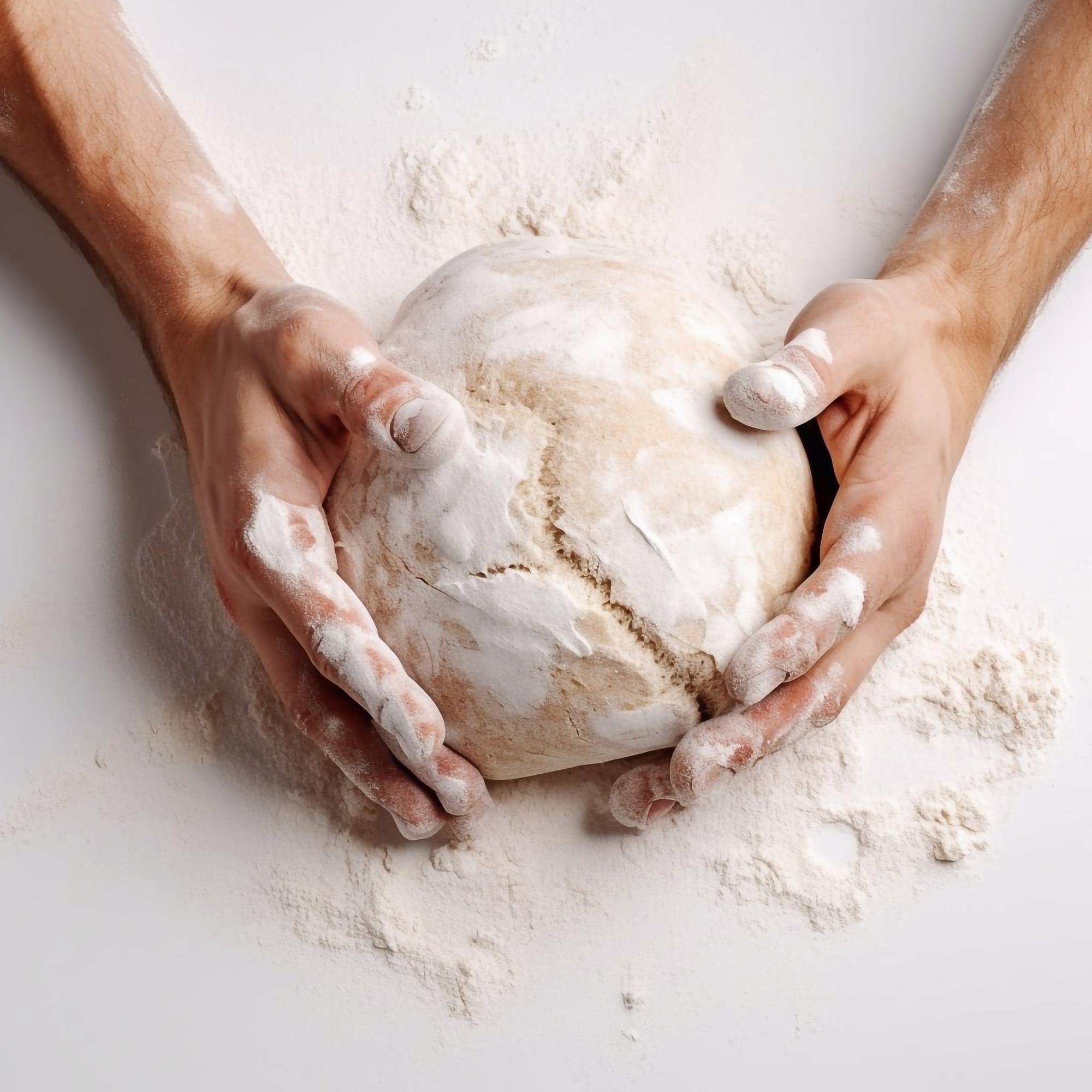 Close-up of hands kneading dough